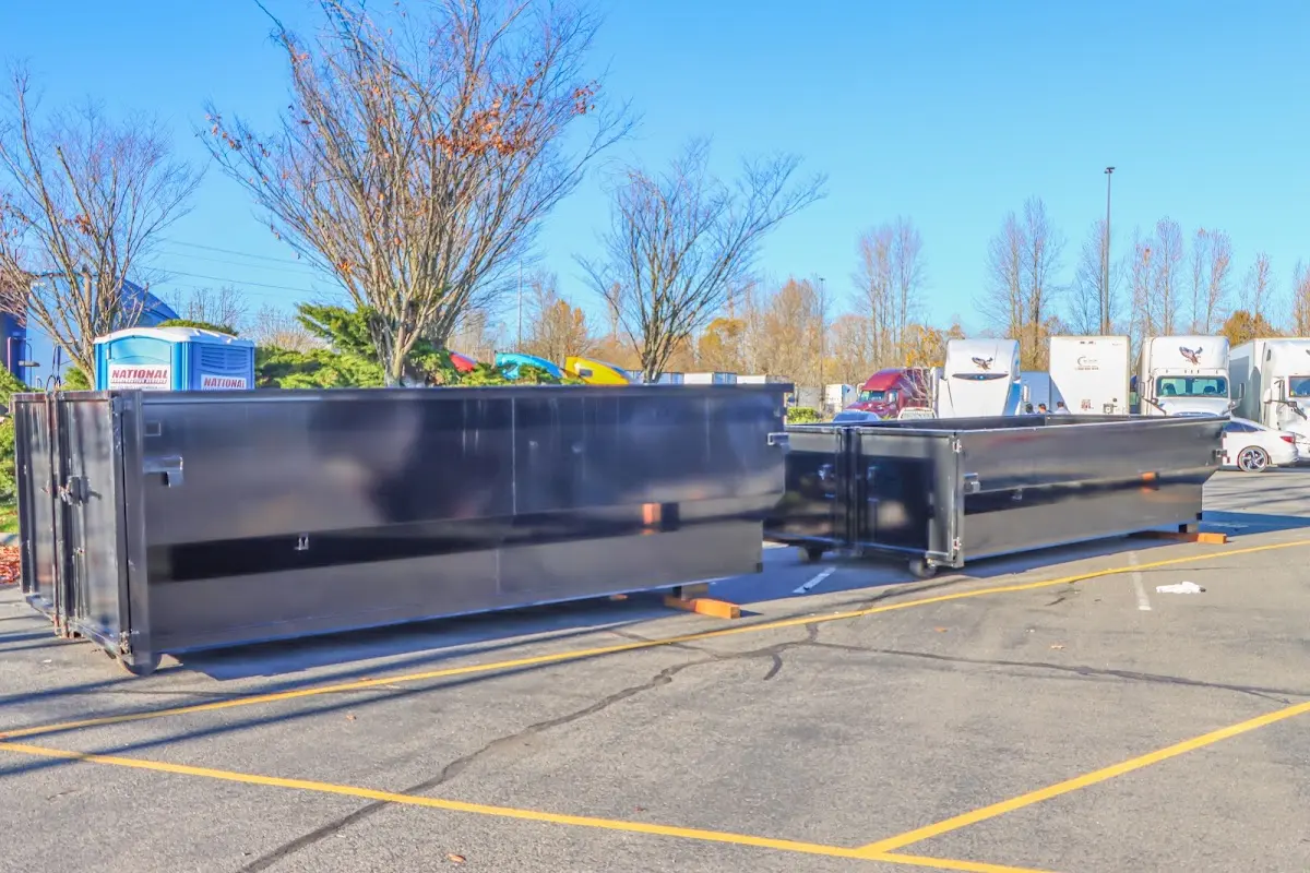 Professional dumpster rental service with roll-off container on residential driveway in Deschutes River Woods